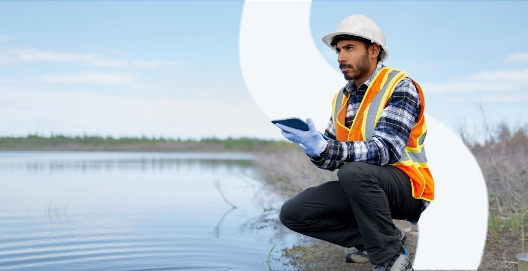 water-engineer with WSP logo Image of New Zealand water engineer taking notes about a water source with the WSP logo in the background
