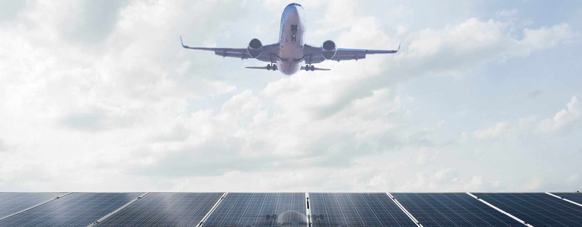 Airplane in flight and view of solar panels in the background | WSP