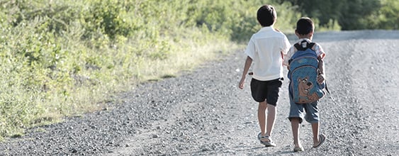 Two children walk along a Philippine road where WSP was selected to develop a road management program